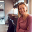 Head And Shoulders Portrait Of Smiling Mature Businesswoman  Working In Modern Office